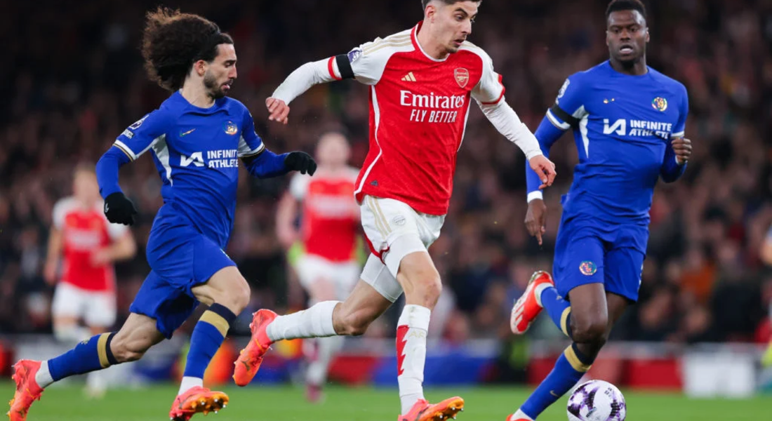 Kai Havertz of Arsenal runs under pressure from Marc Cucurella and Benoit Badiashile of Chelsea during the Premier League match between Arsenal FC ...